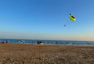 Families enjoying exciting beach activities and relaxing by the serene shores of Nagoa Beach in Diu, featured on the 8 Days Gujarat Family Holiday Package.