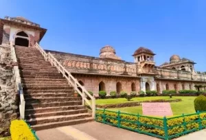 The magnificent ship-like architecture of the historic Jahaz Mahal gracefully floating between two lakes in Mandu, featured on the 8 Days Madhya Pradesh and Gujarat Tour.