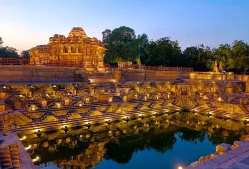 The beautifully illuminated Modhera Sun Temple at night, a stunning architectural masterpiece and a highly popular day trip destination from Ahmedabad.