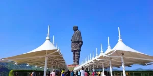 The colossal Statue of Unity towering over the Narmada River and surrounding mountain ranges, experienced during a private premium day trip from Ahmedabad.