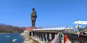 The colossal Statue of Unity towering over the Narmada River and surrounding mountain ranges, experienced during a private premium day tour from Vadodara.