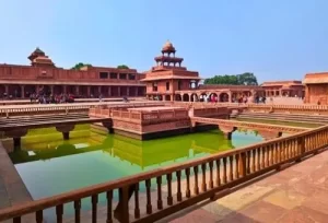 The striking Indo-Islamic red sandstone architecture and grand courtyards of the Mughal ghost city of Fatehpur Sikri, explored during a half-day heritage trip from Agra.