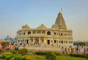 The stunning white marble architecture and intricate carvings of the Prem Mandir in Vrindavan during the day, explored on a same-day spiritual tour from Agra.