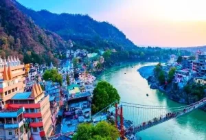 The iconic Ram Jhula suspension bridge hanging over the holy Ganges River, visited during a spiritual Rishikesh day trip from Delhi.
