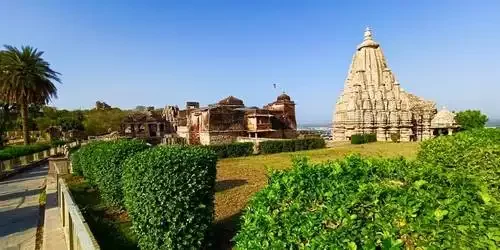 Intricately carved stone pillars and majestic traditional architecture inside an ancient Hindu temple within the Chittorgarh Fort complex in Rajasthan.