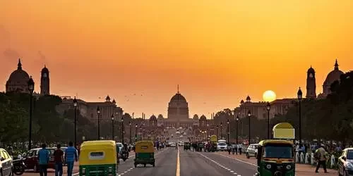 A stunning view of the majestic Rashtrapati Bhavan (Presidential Residence) in New Delhi, bathed in warm, golden hues during a peaceful sunset.