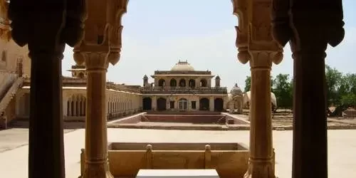A wide shot of the majestic sandstone walls and beautifully restored palaces of Ahichhatragarh Fort (Nagaur Fort) under a bright sky in Nagaur, Rajasthan.